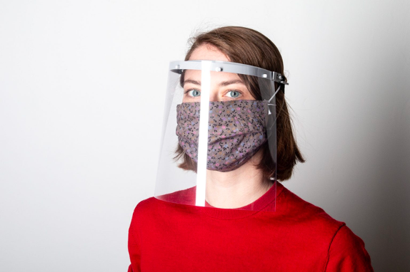 Woman with a face mask face shield during covid 19 protection
